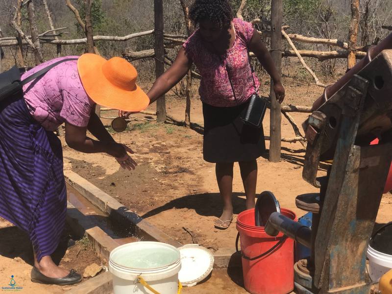 Women fetching water at a bush pump